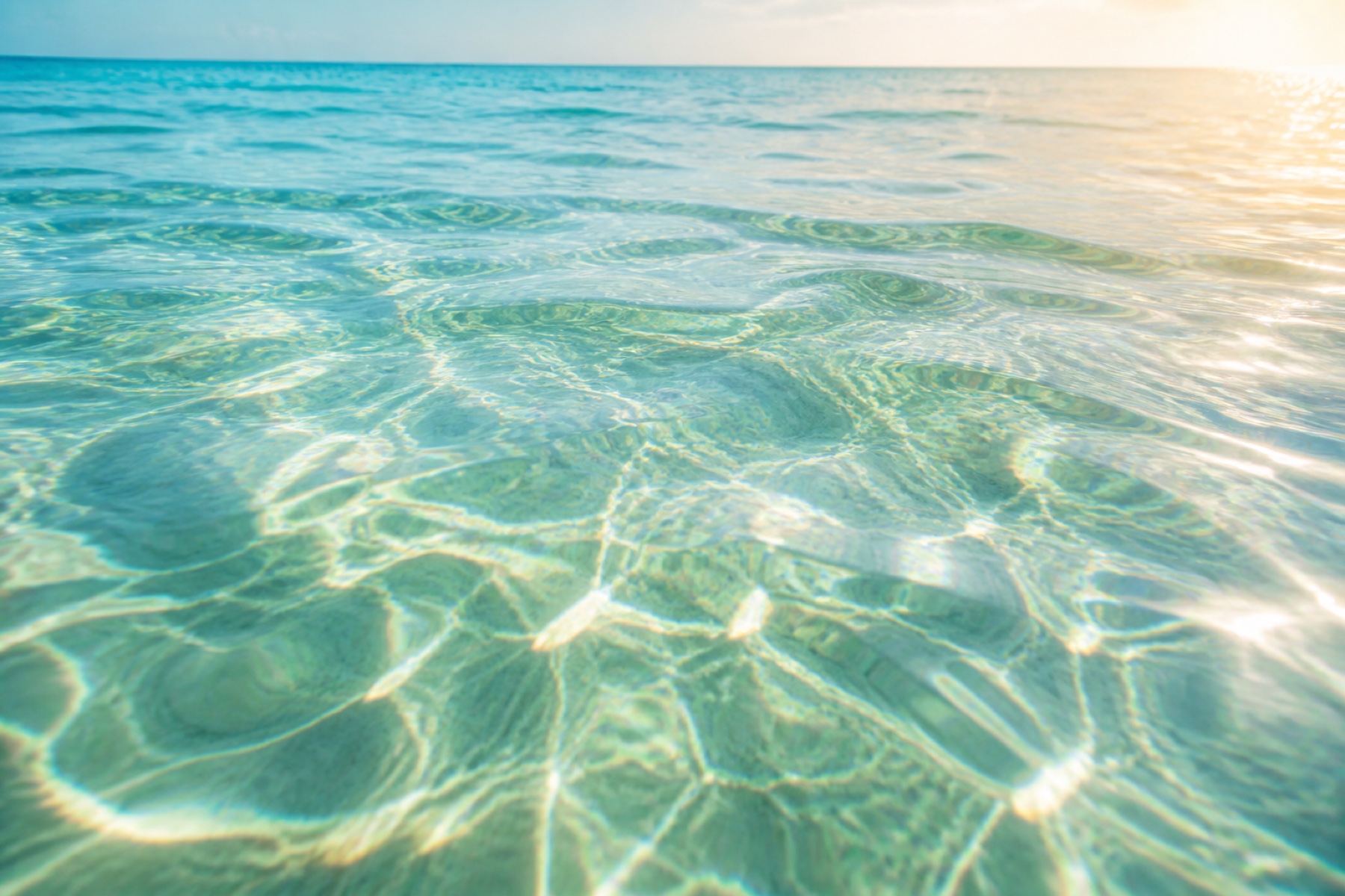 Sunlight moving across clear aquamarine living waters